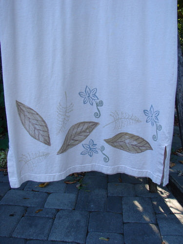 1999 Straight Dress Window Chair Teadye Size 0 hangs outdoors, showcasing organic cotton with nature-inspired embroidery. Features rounded pockets, paneled neckline, widening hips, vented hemline, and signature Blue Fish patch.