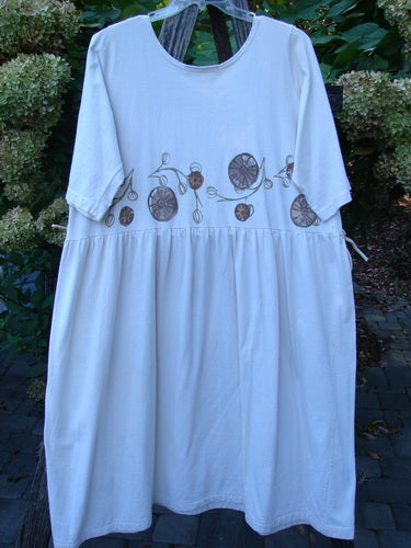 1994 Flower Garden Dress Garden Trail Altered Ecru Size 2 features a loose-fitting, knee-length design with elbow-length sleeves, a gathered waistline, and stylized circular motifs, perfect for a whimsical garden party.