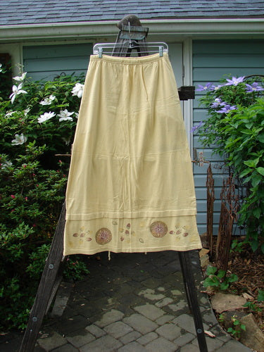 1999 Basket Skirt Fruit Slice Buttercup Size 1 displayed on a clothes rack, featuring a full elastic waistband, deep side pockets, and an A-line flare with a unique fruit slice theme.