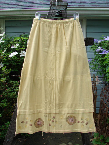 1999 Basket Skirt Fruit Slice Buttercup Size 1, featuring intricate embroidery, a full elastic waistband, deep side pockets, A-line flair, and a unique bottom panel with fruit slice motifs.