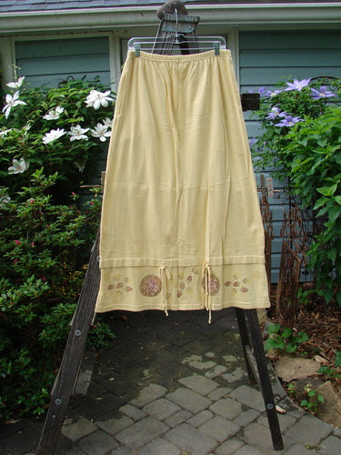 1999 Basket Skirt Fruit Slice Buttercup Size 1 displayed on a clothes rack, highlighting its full elastic waistband, deep side pockets, and specialized fruit slice-themed bottom panel.