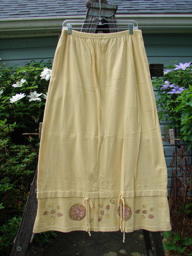 1999 Basket Skirt Fruit Slice Buttercup Size 1 featuring intricate embroidery, full elastic waistband, deep side pockets, and a unique fruit slice pattern, displayed on a clothesline.
