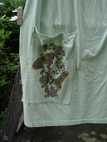 1994 Pocket Skirt Magical Garden Seawater Size 1 featuring a front pocket with butterfly fabric, drawcord waistline, and side vent, hanging on a clothesline.