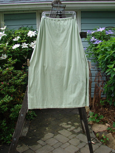 1994 Pocket Skirt Magical Garden Seawater Size 1 displayed on a wooden stand, highlighting a fun lower front pocket with garden-themed paint and a full drawcord waistline.