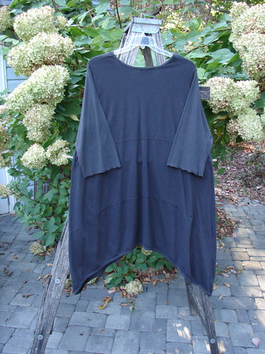Barclay Perfect Day Dress Unpainted Black Size 2, displayed on a wooden ladder, features elbow-length sleeves, a subtle V-neck, oversized pockets, and lettuce edges, embodying BlueFishFinder's vintage, creative style.