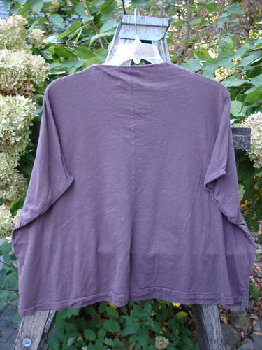 Barclay NWT Cotton Slub Cricket Cap Sleeve Tee Travel By Sun Fig OSFA, a loose-fitting, long-sleeve top displayed on a wooden support, highlighting its seamless shoulder sleeves and breathable fabric.