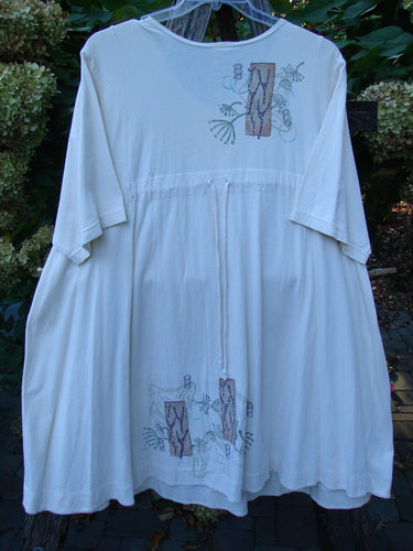 Barclay Tunnel Pocket Pull Over Dress Fish Natural Size 2, featuring a loose-fitting smock style with elbow-length sleeves, drawstring waist, tree trunk and botanical prints, and a generous front drop tunnel kangaroo pocket.