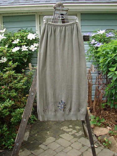 1996 Cotton Cashmere Skirt Pinwheel Green Shade on Shade Size 2 displayed draped over a wooden ladder, highlighting its full elastic waistband with drawcord and two deep side pockets.