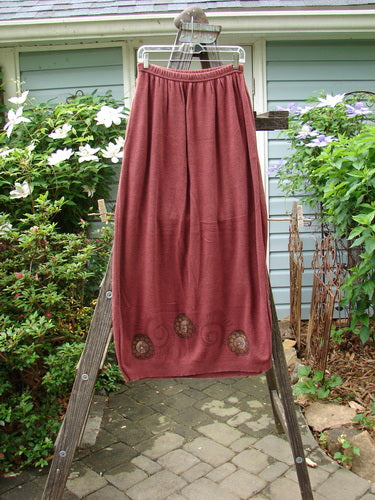 1997 Cotton Cashmere Skirt Pinwheel Marled Stained Glass Size 2, displayed on a wooden ladder, showcasing its full-length design and soft, densely knit fabric with a slightly tapered hem.