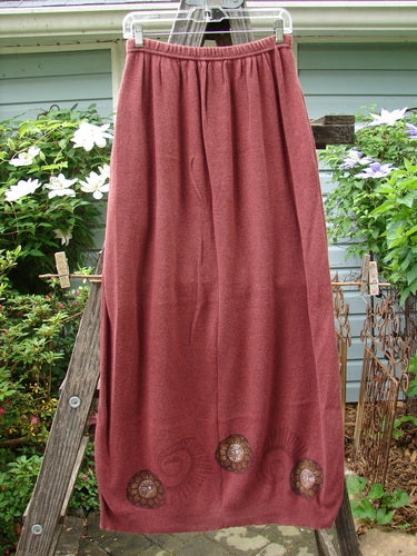 1997 Cotton Cashmere Skirt Pinwheel Marled Stained Glass Size 2, displayed draped over a wooden ladder, showcasing its full elastic waistband, deep side pockets, and pinwheel design.