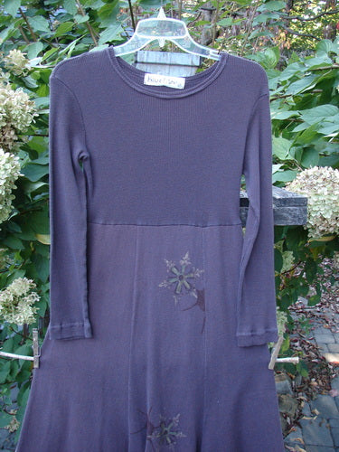 1998 Rib Top Dress Snowflake Morado Size 0 featuring a ribbed turtleneck, empire waist, and full floral skirt, displayed on a hanger outdoors amidst garden greenery, showcasing vintage Blue Fish Clothing charm.