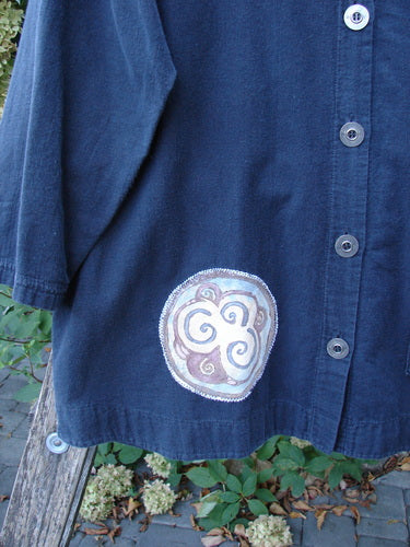 Barclay Patched Flannel PJ Pom Pom Top Pinwheel Black Size 0 draped over a bench, featuring elbow-length sleeves, four buttons, a pinwheel patch, and an oversized pocket with pom-pom accents.