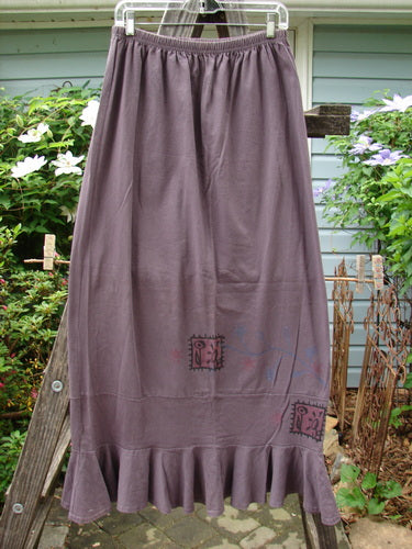 1996 Spring Laughter Skirt Stitch Vine Violet Field Size 2 displayed on a clothes hanger, showcasing its full elastic waistband, slimming drape, and detailed vine stitching with a fun flounce accent.