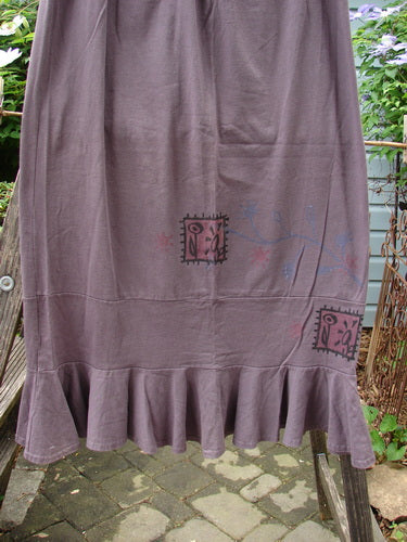 1996 Spring Laughter Skirt Stitch Vine Violet Field Size 2: A purple skirt featuring a ruffled hem, full elastic waistband, straight shape, and intricate vine stitching.