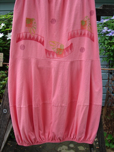 1997 Promenade Skirt Wave Shell Tulip Size 1, showcased on a clothes rack, highlighting its full elastic waist, segmented horizontal seams, gathered hem, and two deep side pockets, all in organic cotton.