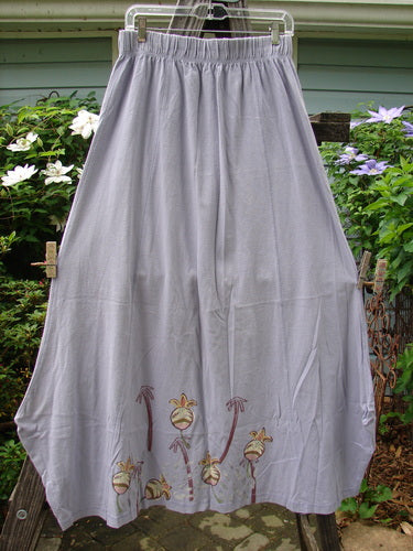 1998 Botanicals Gillyflower Skirt Bud Wisteria Size 2 hanging on a clothesline, featuring a floral design, sectional curvy seams, and a specialized hem, made from mid-weight organic cotton.