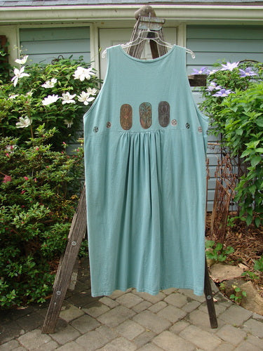 1993 Button Jumper featuring vintage carved stone theme paint, oversized buttons, and tunnel pockets displayed on a rack.