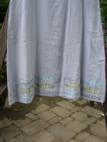 1999 Handkerchief Linen Sunbeam Dress Fish Water Size 1: A white dress with colorful fish designs, featuring an empire waist seam, full-length skirt, and sectional panels, perfect for summer days.