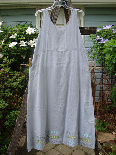 1999 Handkerchief Linen Sunbeam Dress Fish Water Size 1 hanging on a clothesline, showcasing its full-length sweeping skirt, empire waist, and sectional panels.