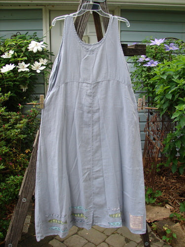 1999 Handkerchief Linen Sunbeam Dress Fish Water Size 1 hanging on a clothesline, showcasing its full-length sweeping skirt and empire waist seam.