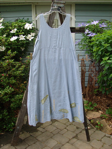 1999 Handkerchief Linen Sunbeam Dress Leaf Water Size 1 on a clothes rack, showcasing a full-length sweeping skirt, empire waist seam, and sectional panels with a sweet leaf theme paint.