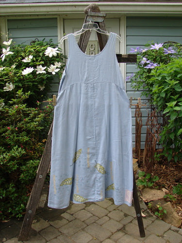 1999 Handkerchief Linen Sunbeam Dress Leaf Water Size 1: A full-length dress with an empire waist seam, sectional panels, and sweet leaf theme paint, displayed on a rack.