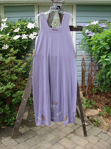 2000 Eiffel Dress Spaceship Twilight Size 1 displayed on a wooden rack, showcasing its unique triangular neckline insert and sectional panels.