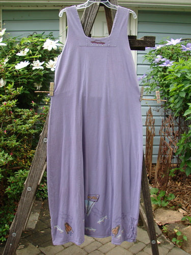 2000 Eiffel Dress Spaceship Twilight Size 1, displayed on a wooden rack, showcasing its gathered upper, curved empire waistline, and unique triangular neckline insert.