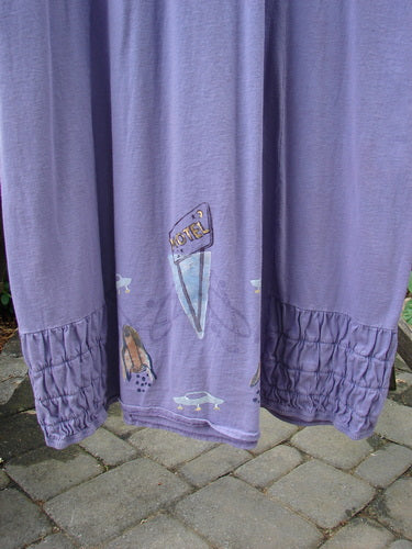 2000 Eiffel Dress Spaceship Twilight Size 1, featuring a unique gathered upper, downward curved empire waistline, and spaceship-themed drawings on purple organic cotton.