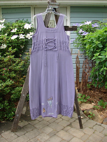 2000 Eiffel Dress Spaceship Twilight Size 1 displayed on a wooden rack, featuring gathered upper, curved empire waistline, triangular neckline insert, and sectional panels.