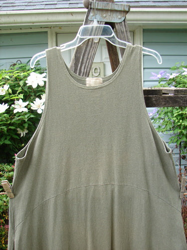 2000 Libby Jumper Honey Hive Loden Size 2 displayed on a hanger, showcasing its sophisticated drape, downward scooped waistline, side pockets, and bubbled shape with a varying elastic hemline.