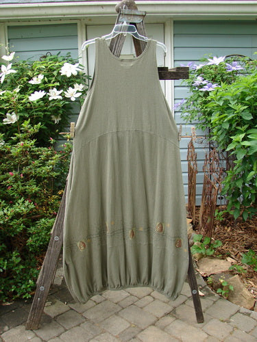 2000 Libby Jumper Honey Hive Loden Size 2 displayed on a wooden rack, highlighting its sophisticated drape, downward scooped waistline, and side pockets, showcasing the unique honey and bee hive theme.