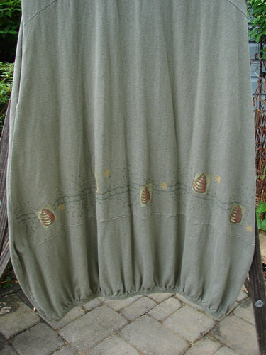 2000 Libby Jumper Honey Hive Loden Size 2 displayed on a stone surface, featuring a scooped waistline, side pockets, and bee-themed design.