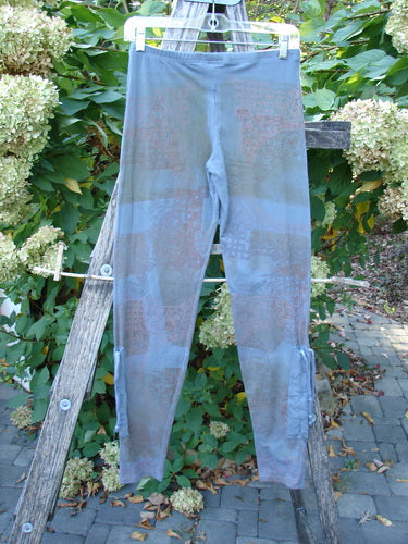 Barclay Cotton Lycra Side Gather Legging Lattice Moss Size 0, showcasing slim-fit design with drawcord accents, elegantly hung on a ladder against a garden setting, capturing its unique style and springtime appeal.