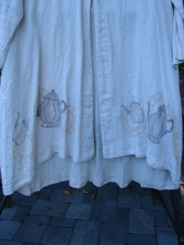 1999 NWT Cream and Sugar Coat Tea Time Teadye OSFA, showcasing a stenciled teapot motif along the hem, with a distinctive widening drape and single oversized shell button, perfect for vintage Blue Fish enthusiasts.