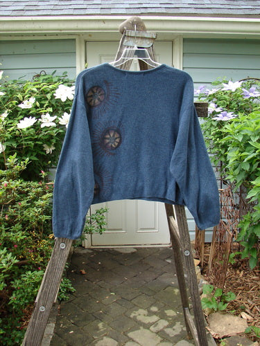 1997 Cotton Cashmere Crop Pullover Star Wheel Marled Blueprint Size 3 draped over a wooden ladder, showcasing its slightly shorter boxy shape, drop shoulders, and rolled ribbed neckline.