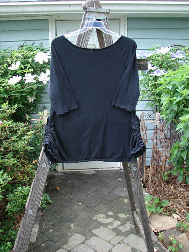 Barclay Boatneck Draw Side A Line Top Unpainted Black Size 1 displayed on a wooden ladder, highlighting its boat neckline, three-quarter sleeves, drawcord sides, and A-line shape.