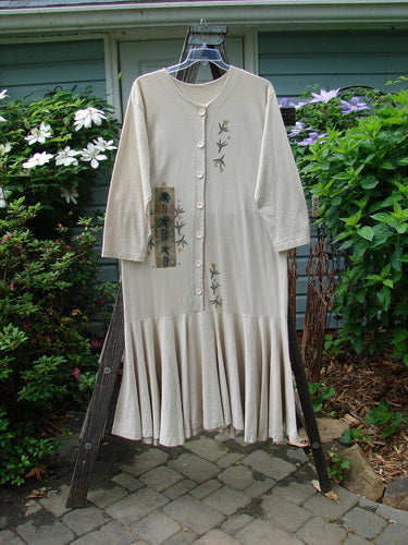 1994 Column Dress Magic Star Mist Size 2 displayed on a rack, featuring a full front button design, V-shaped neckline, longer sleeves, and a full bottom kick flounce.