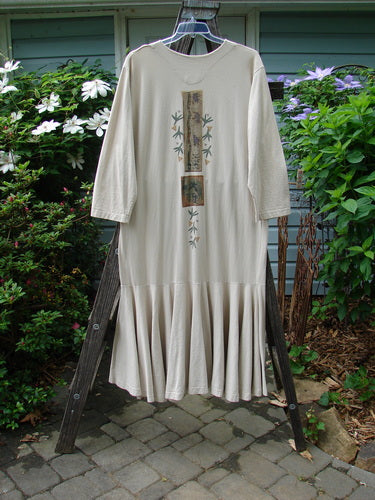 1994 Column Dress Magic Star Mist Size 2 on a wooden rack, featuring a full front button duster shape, V-shaped neckline, longer sleeves, and a full bottom kick flounce.