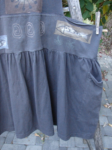 1995 Overall Jumper Fish Space Briquette OSFA: Dark-gray smock-style dress with graphic prints, gathered skirt, and roomy pocket, featuring crisscross back straps. Perfect vintage layering piece from Bluefishfinder.com’s vintage collection.