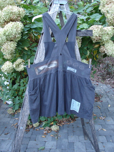 1995 Overall Jumper Fish Space Briquette OSFA displayed on a rustic ladder, features wide cross-back straps, a full gathered skirt, oversized pockets, and unique appliqués, epitomizing BlueFishFinder's vintage, artistic style.