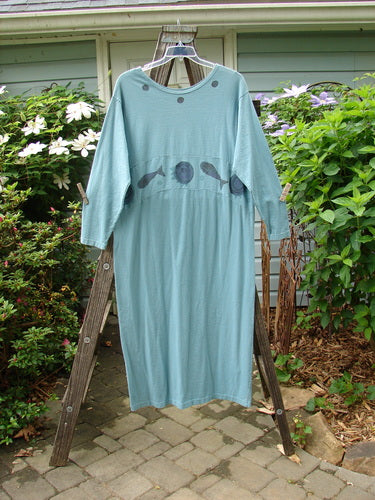 1995 Empire Dress Moon Fish Venus Size 2 displayed on a wooden ladder, showcasing a unique downward curved waist panel, rolled neckline, tighter sleeves, and a rare moon and fish pattern.