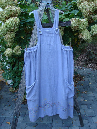 2000 Hemp Summercloth Hi Way Overall Jumper Star Border Twilight Size 2, featuring adjustable buckle straps, large patch pockets, and subtle embroidery, draped over a garden ladder amidst blooming hydrangeas.