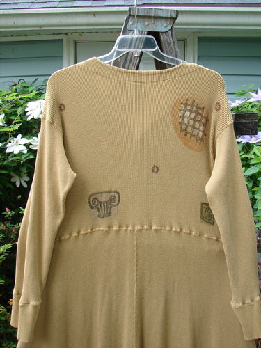 1995 Thermal Soliloquy Dress Architectural Burnished Gold Size 2 displayed on a hanger, featuring front snaps, ribbed sleeves, and an abstract architectural design.