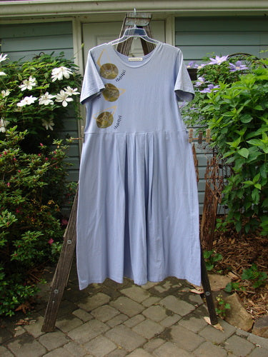1997 Lawn Dress Side Geo Freesia Size 1 displayed on a hanger. Features tailored pleats, drop waistline, wider neckline, geometric pattern, and signature blue fish patch.
