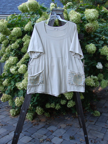 A white shirt with pockets on a wooden ladder, part of the Barclay Be There Top Moon Twig Dust Size 2 collection.