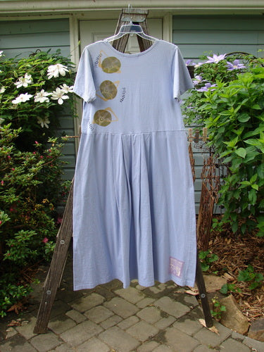 1997 Lawn Dress Side Geo Freesia Size 1 displayed on a rack, featuring tailored pleats, drop waistline, and a flattened neckline, adorned with the classic Geo theme paint and signature Blue Fish patch.