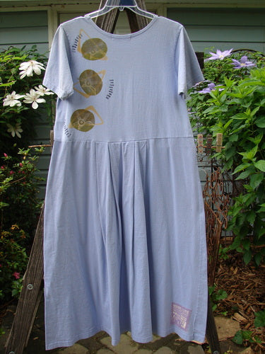 1997 Lawn Dress Side Geo Freesia Size 1. Features include a painted geometric design, tailored pleats, drop waistline, and a Blue Fish patch. Made from organic cotton.