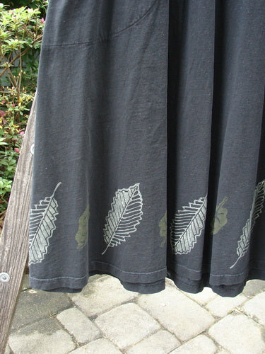 2000 LuLu's Dress Leaf Black Size 0: Black dress with leaf design, drop yoke waistline, inseam pockets, four-button top closure, swingy lower, pleated front darts, and decorative loops.