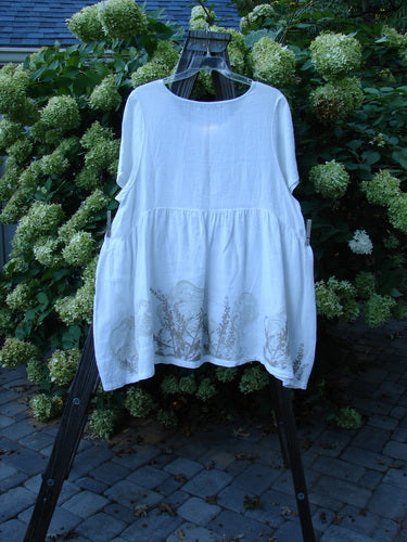 Barclay Linen Studio Pullover Dress Breeze Fern White Size 2 on a rack, showcasing its flouncy lower skirt, gathered waistline, wide hem sweep, and unique figure 8 front bodice seams.
